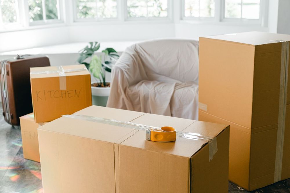 Moving boxes in a bright room in Bethany, CT before or after carpet cleaning