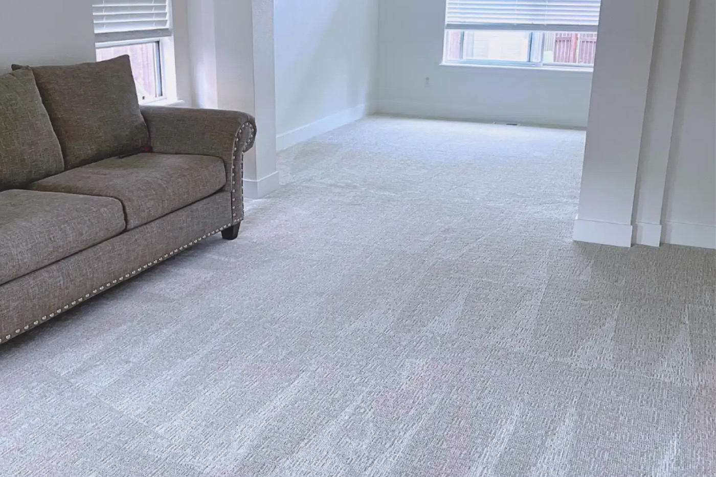 Professional carpet cleaning technician using an extraction wand in a Connecticut living room